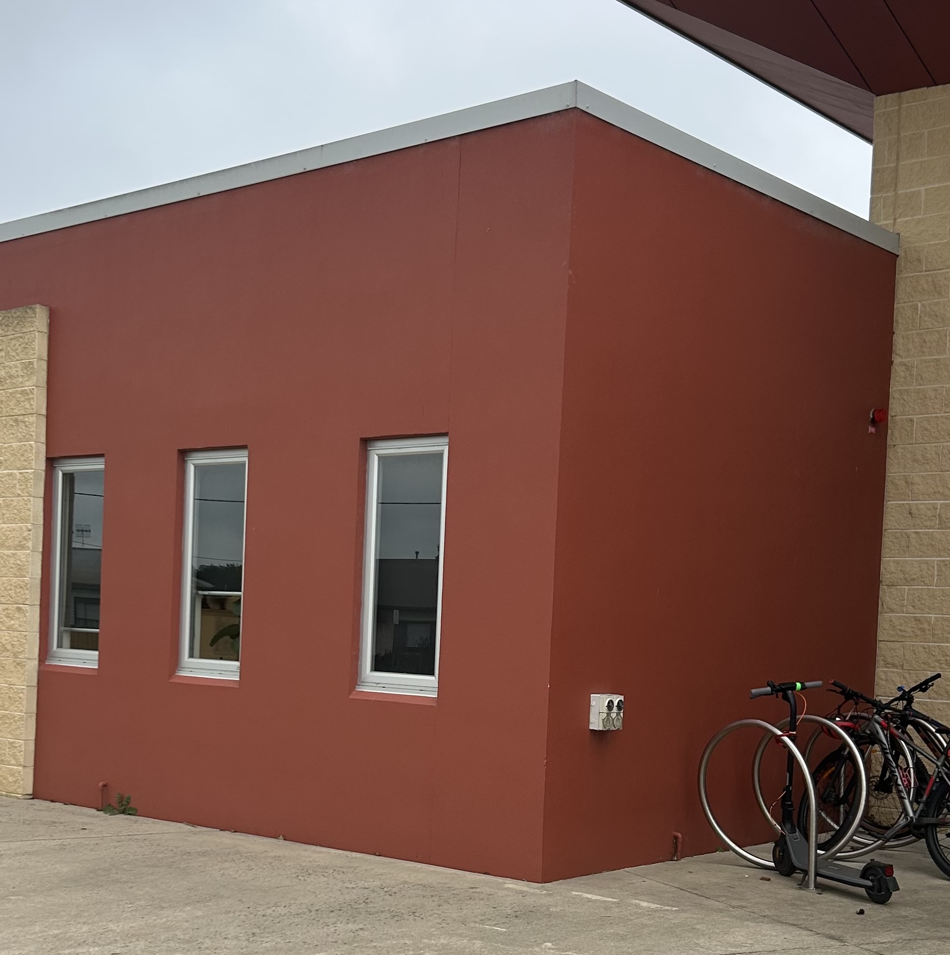 Commercial building with terracotta rendered wall and stone feature blockwork